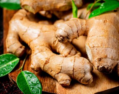 Ginger on a wooden cutting board. On a rustic dark background. High quality photo
